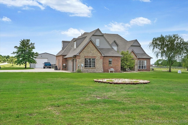 craftsman house with brick siding, roof with shingles, a front yard, and a detached garage
