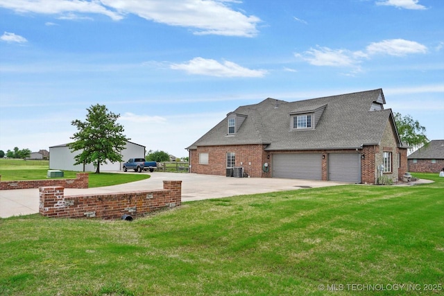view of front facade with brick siding, a garage, driveway, and a front yard