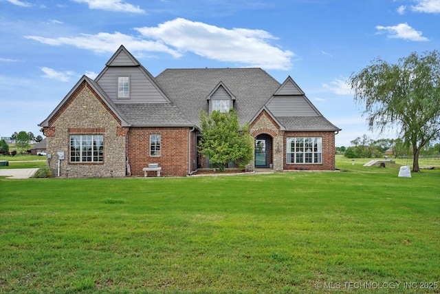 view of front of property featuring brick siding and a front yard
