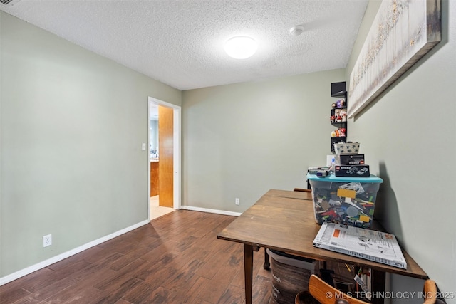 home office with baseboards, a textured ceiling, and wood finished floors