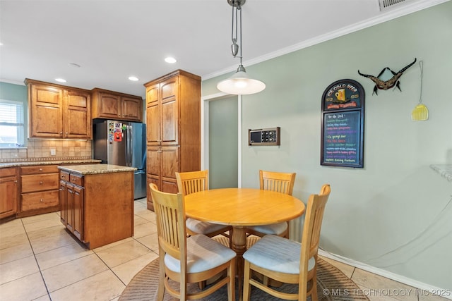 dining area with crown molding, recessed lighting, and light tile patterned flooring