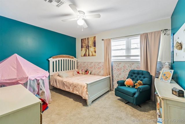 bedroom with visible vents, wallpapered walls, ceiling fan, and light colored carpet