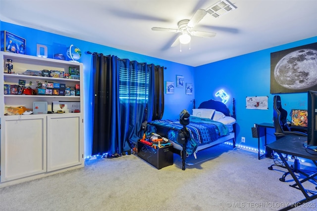 carpeted bedroom with visible vents and a ceiling fan