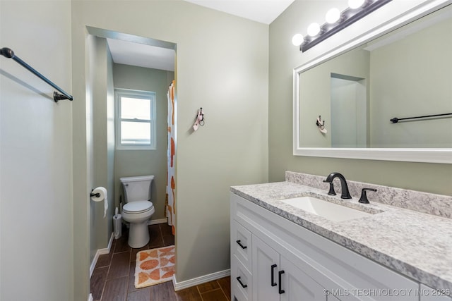 full bathroom with toilet, baseboards, wood tiled floor, and vanity