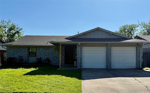 single story home featuring a shingled roof, an attached garage, stone siding, a front yard, and driveway