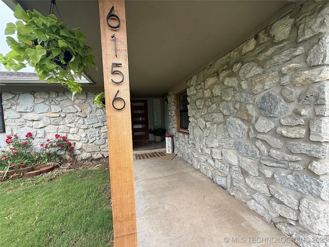 entrance to property with stone siding