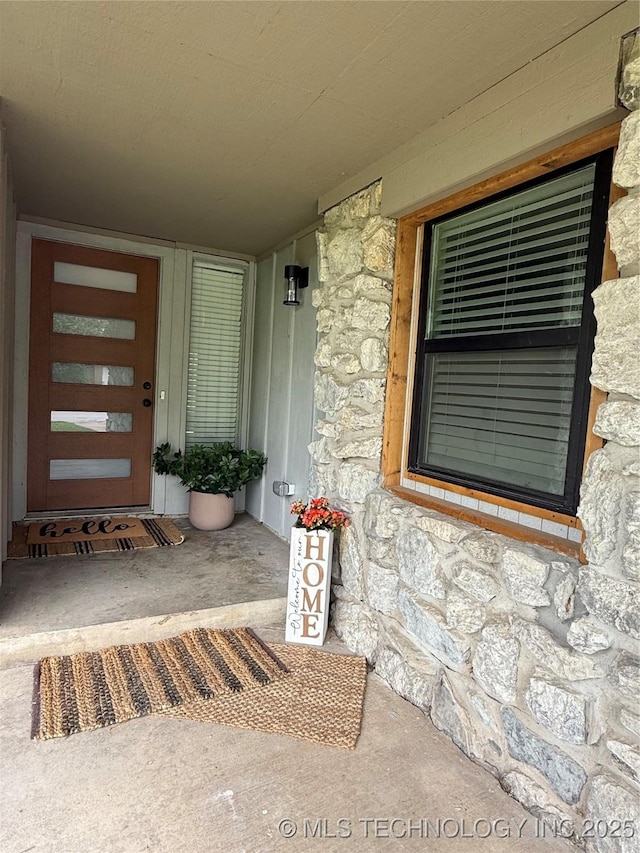 property entrance with stone siding