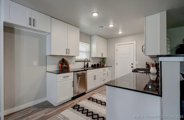 kitchen featuring visible vents, recessed lighting, light wood-type flooring, a sink, and dishwasher