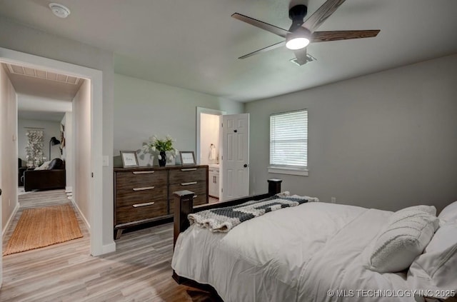 bedroom featuring baseboards, a ceiling fan, light wood-style flooring, and visible vents