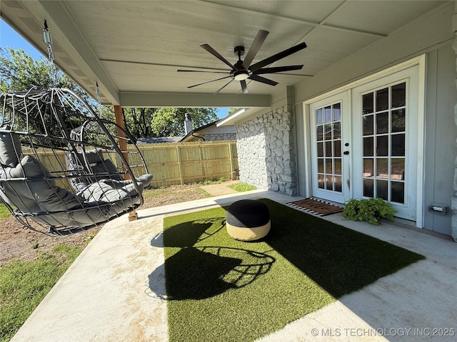view of patio featuring ceiling fan, fence, and french doors