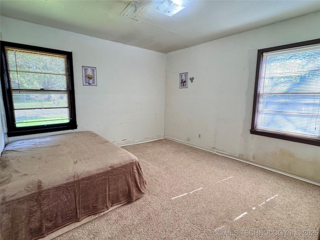 carpeted bedroom with baseboards