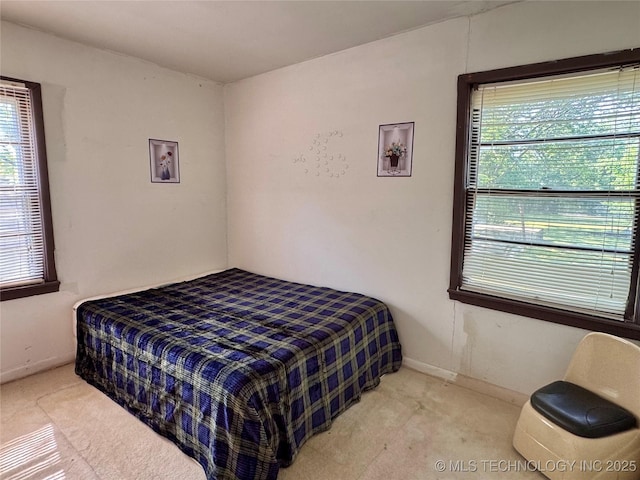 carpeted bedroom with baseboards