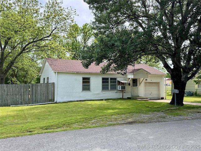 ranch-style home with an attached garage, driveway, and roof with shingles