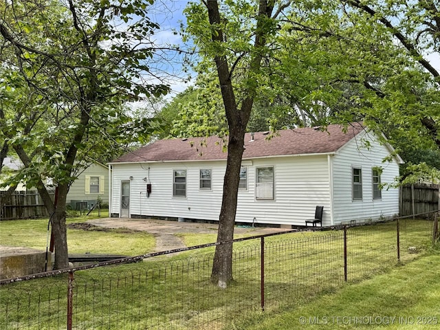 back of property featuring roof with shingles