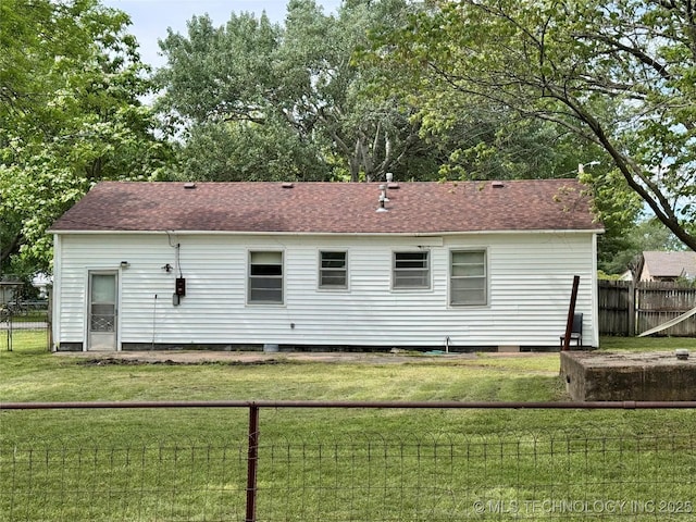 rear view of property with roof with shingles