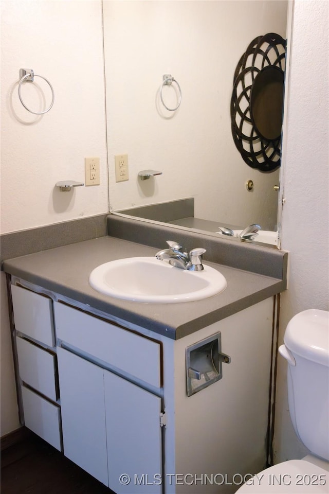 bathroom with vanity and toilet