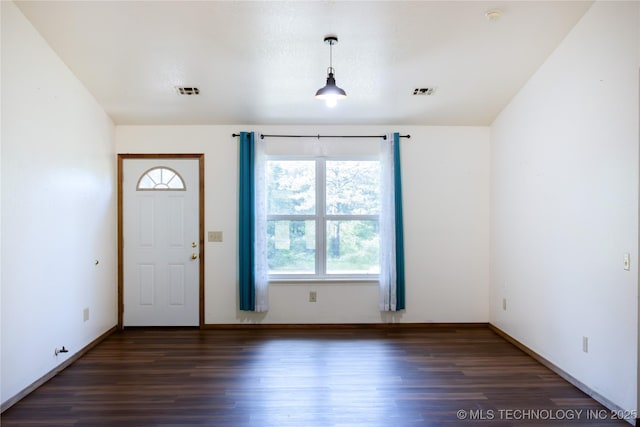entryway featuring baseboards, wood finished floors, and visible vents