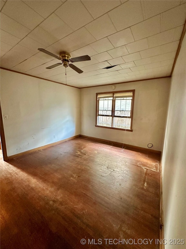 unfurnished room featuring ceiling fan, baseboards, and wood finished floors