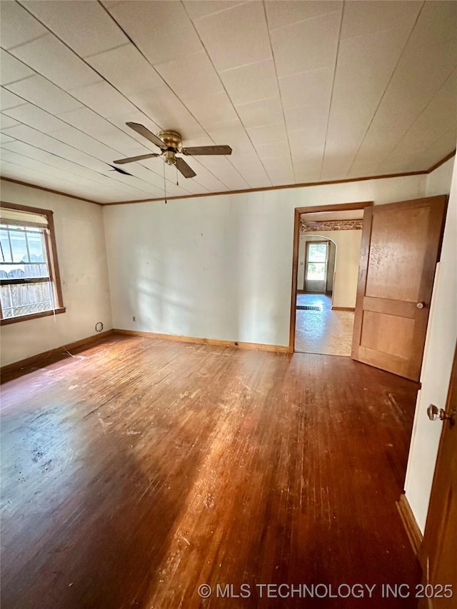 unfurnished room with a healthy amount of sunlight, baseboards, ceiling fan, and hardwood / wood-style floors