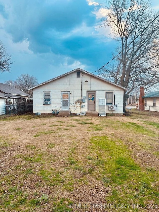 back of house with a lawn, ac unit, fence, and entry steps