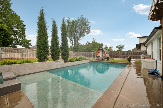view of pool with a fenced backyard
