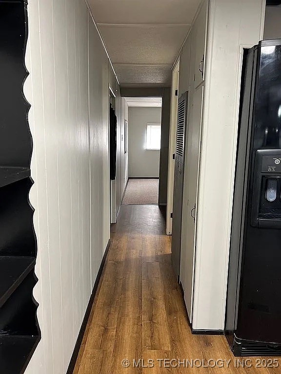 corridor featuring dark wood finished floors