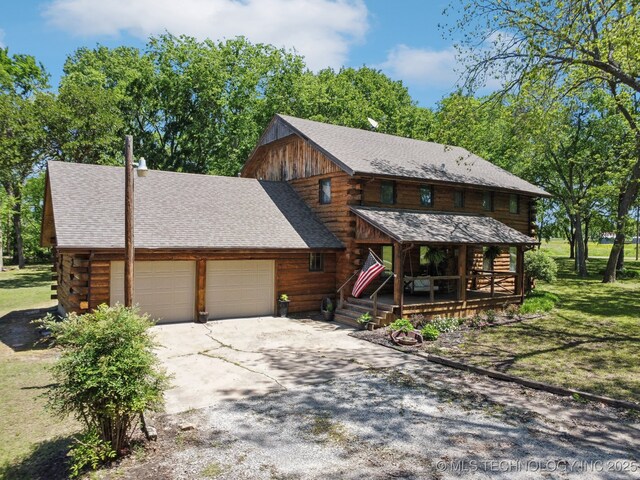 log home featuring an attached garage, log exterior, a shingled roof, concrete driveway, and a porch