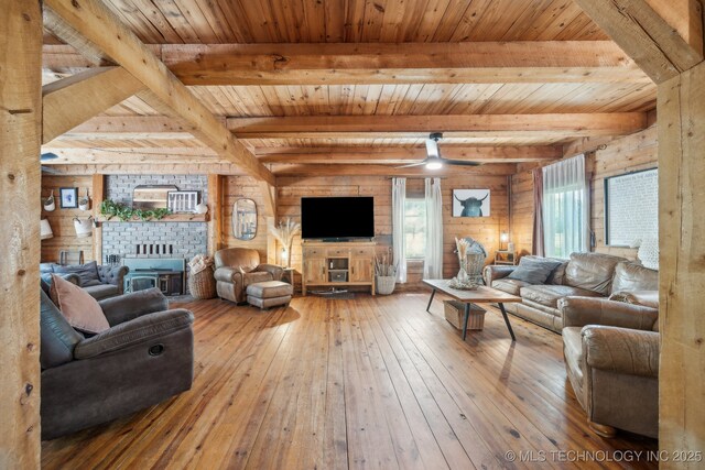 living area with hardwood / wood-style floors, plenty of natural light, and beam ceiling