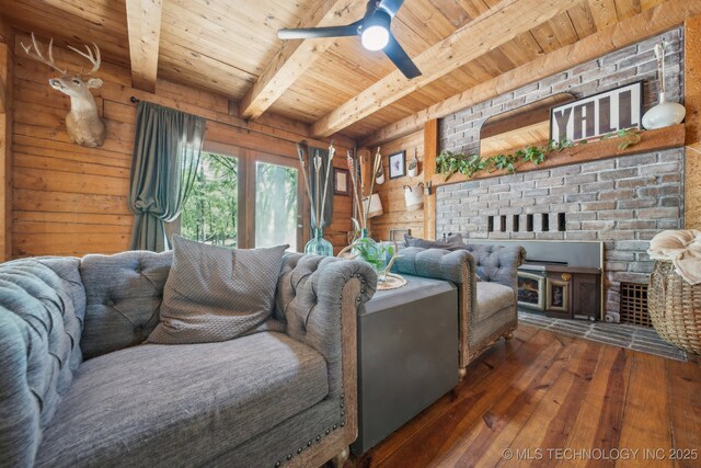 living room featuring wooden ceiling, a fireplace, wood-type flooring, beamed ceiling, and a ceiling fan