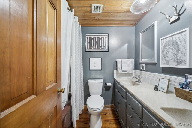 bathroom with toilet, wooden ceiling, double vanity, wood finished floors, and a shower with shower curtain