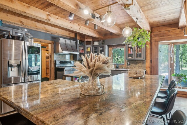 kitchen featuring beam ceiling, exhaust hood, range, wooden ceiling, and tasteful backsplash