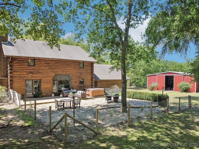 15955 Briar Rd, Morris, OK 74445 - rear view of house featuring a hot tub, log exterior, an outbuilding, and a patio area