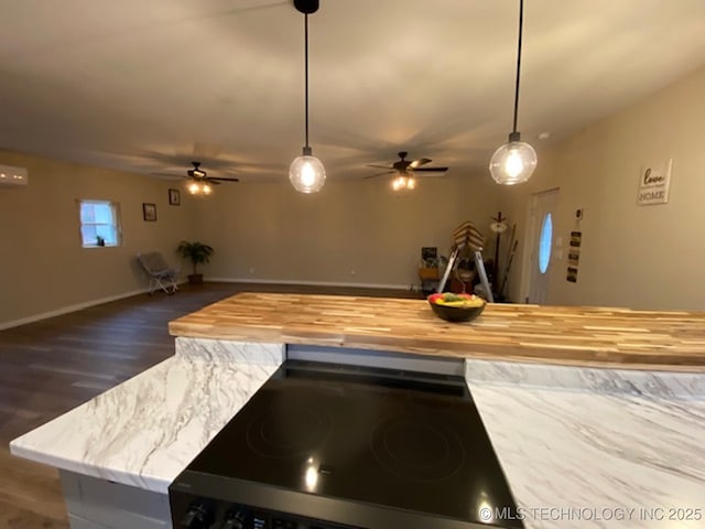kitchen featuring ceiling fan, stove, and open floor plan
