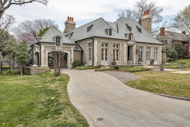 2119 E 30th Pl, Tulsa, OK 74114 - view of front of property with a chimney, a front lawn, and stone siding