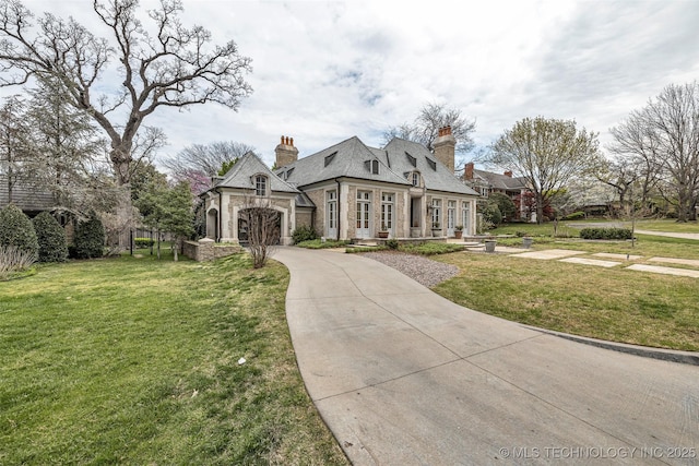 2119 E 30th Pl, Tulsa, OK 74114 - view of front of home with an attached garage, stone siding, driveway, a front lawn, and a chimney