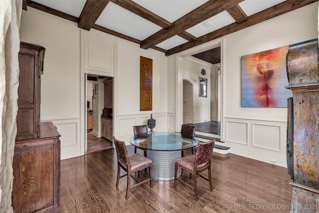2119 E 30th Pl, Tulsa, OK 74114 - dining area featuring coffered ceiling, dark wood finished floors, wainscoting, beamed ceiling, and arched walkways