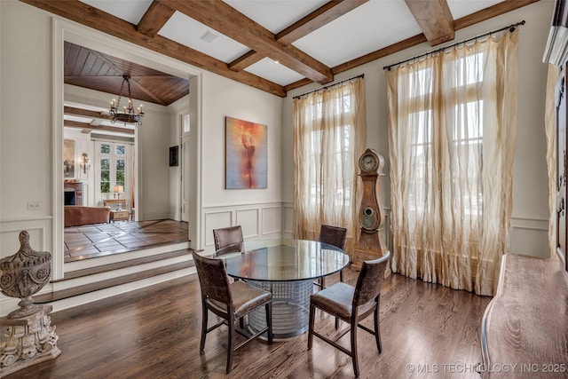 2119 E 30th Pl, Tulsa, OK 74114 - dining area with a decorative wall, beam ceiling, wood finished floors, an inviting chandelier, and coffered ceiling
