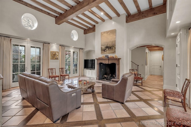 2119 E 30th Pl, Tulsa, OK 74114 - living area with beam ceiling, a fireplace, stairway, a towering ceiling, and arched walkways