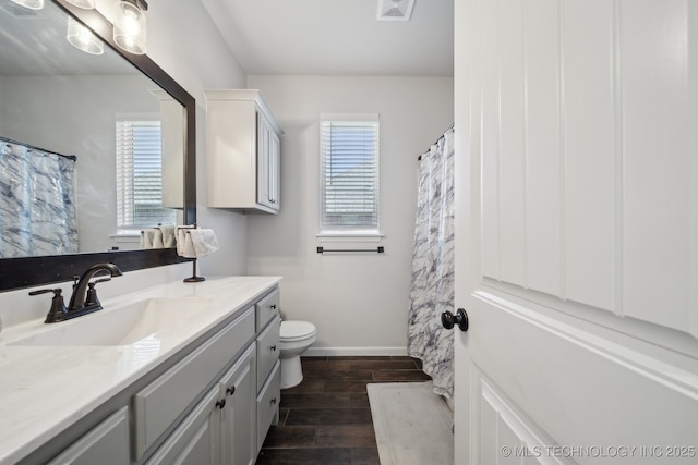 10431 S 232nd E Ave, Broken Arrow, OK 74014 - bathroom with vanity, wood finished floors, toilet, and healthy amount of natural light