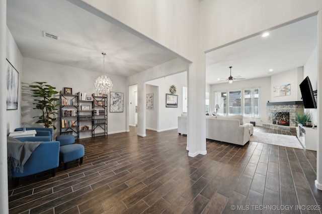 10431 S 232nd E Ave, Broken Arrow, OK 74014 - living area featuring a fireplace, ceiling fan, dark wood-type flooring, a chandelier, and baseboards
