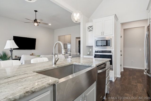 10431 S 232nd E Ave, Broken Arrow, OK 74014 - kitchen with appliances with stainless steel finishes, a sink, light stone counters, dark wood-style floors, and vaulted ceiling