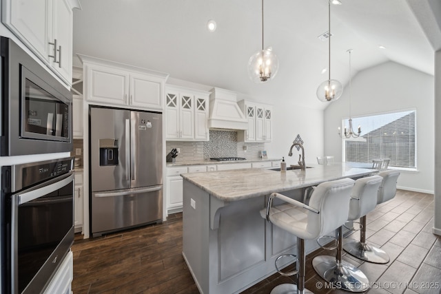 10431 S 232nd E Ave, Broken Arrow, OK 74014 - kitchen with appliances with stainless steel finishes, a sink, custom range hood, a chandelier, and vaulted ceiling