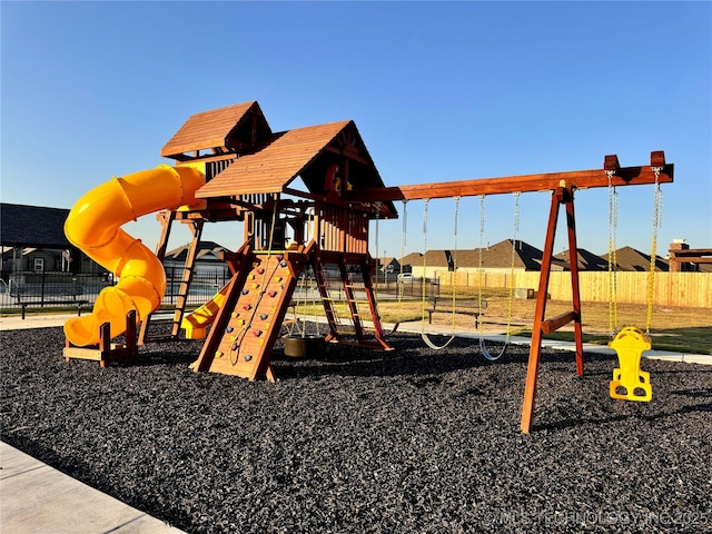 communal playground featuring fence