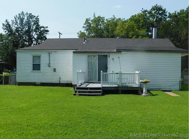 back of property featuring a lawn and a wooden deck