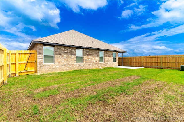 10914 S 272nd E Ave, Coweta, OK 74429 - back of house with a shingled roof, a fenced backyard, brick siding, and a patio