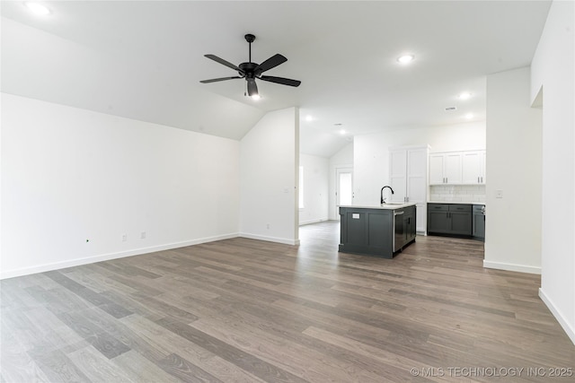 10914 S 272nd E Ave, Coweta, OK 74429 - unfurnished living room with recessed lighting, wood finished floors, a ceiling fan, and vaulted ceiling