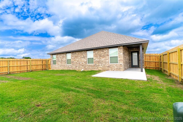 10914 S 272nd E Ave, Coweta, OK 74429 - rear view of house with roof with shingles, a patio area, brick siding, and a fenced backyard