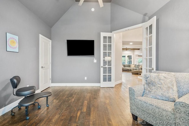 sitting room featuring high vaulted ceiling, ceiling fan, french doors, and wood finished floors