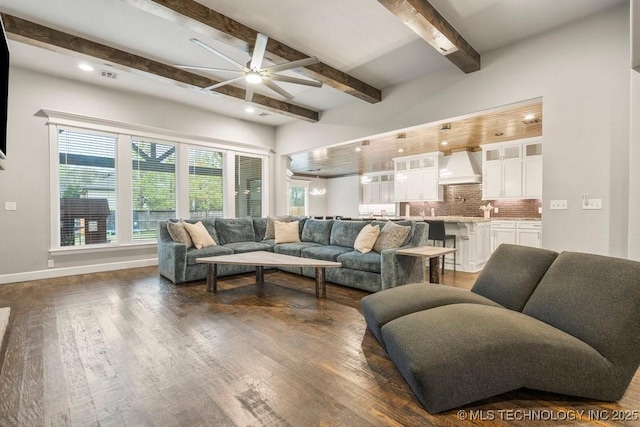 living room with a ceiling fan, visible vents, baseboards, dark wood-style flooring, and beamed ceiling