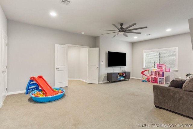 recreation room with carpet flooring, visible vents, and a ceiling fan